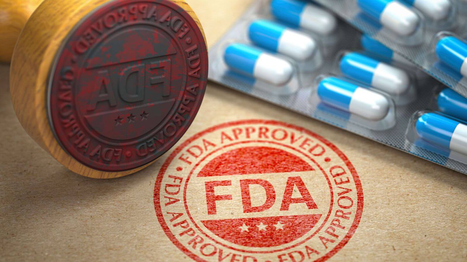 FDA approved stamp next to blue and white capsules in blister pack
